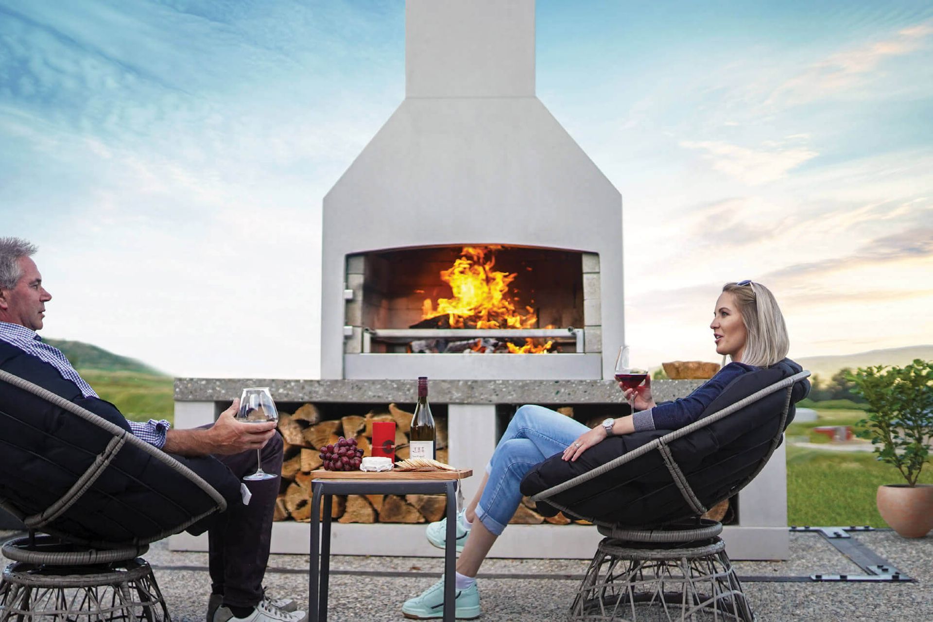 A stylish outdoor fireplace can transform a patio or outdoor dining area. Featured product: Premier Fireplace.