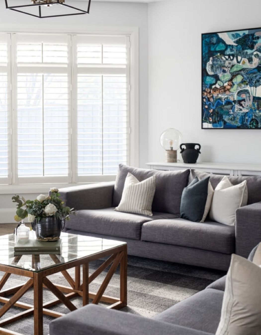 Wall art is commonplace in Hamptons style and coastal living spaces, particularly pieces infused with dark blues and greens. Photography: Dylan James