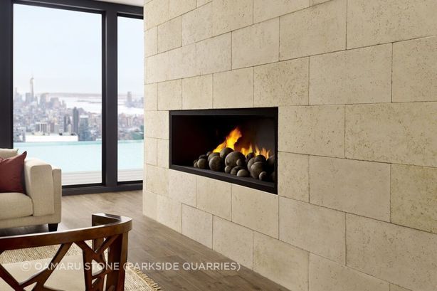 Ōamaru Stone provides a stunning backdrop for a modern fireplace.