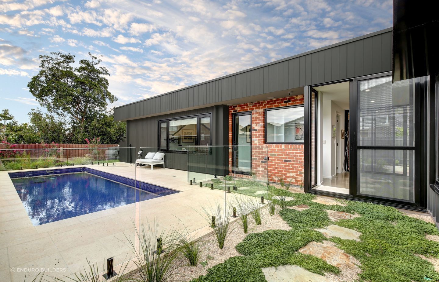 Pavers are a straightforward, practical choice for connecting an outdoor space with a pool area. Featured project: Payneham South - Enduro Builders