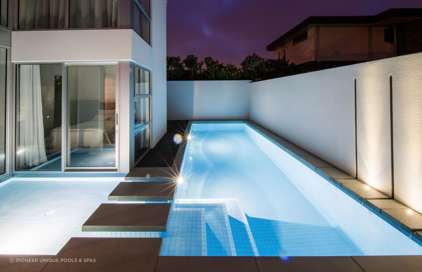 This shotcrete pool by Pioneer Unique Pools &amp; Spas makes use of every inch of its tight suburban site.