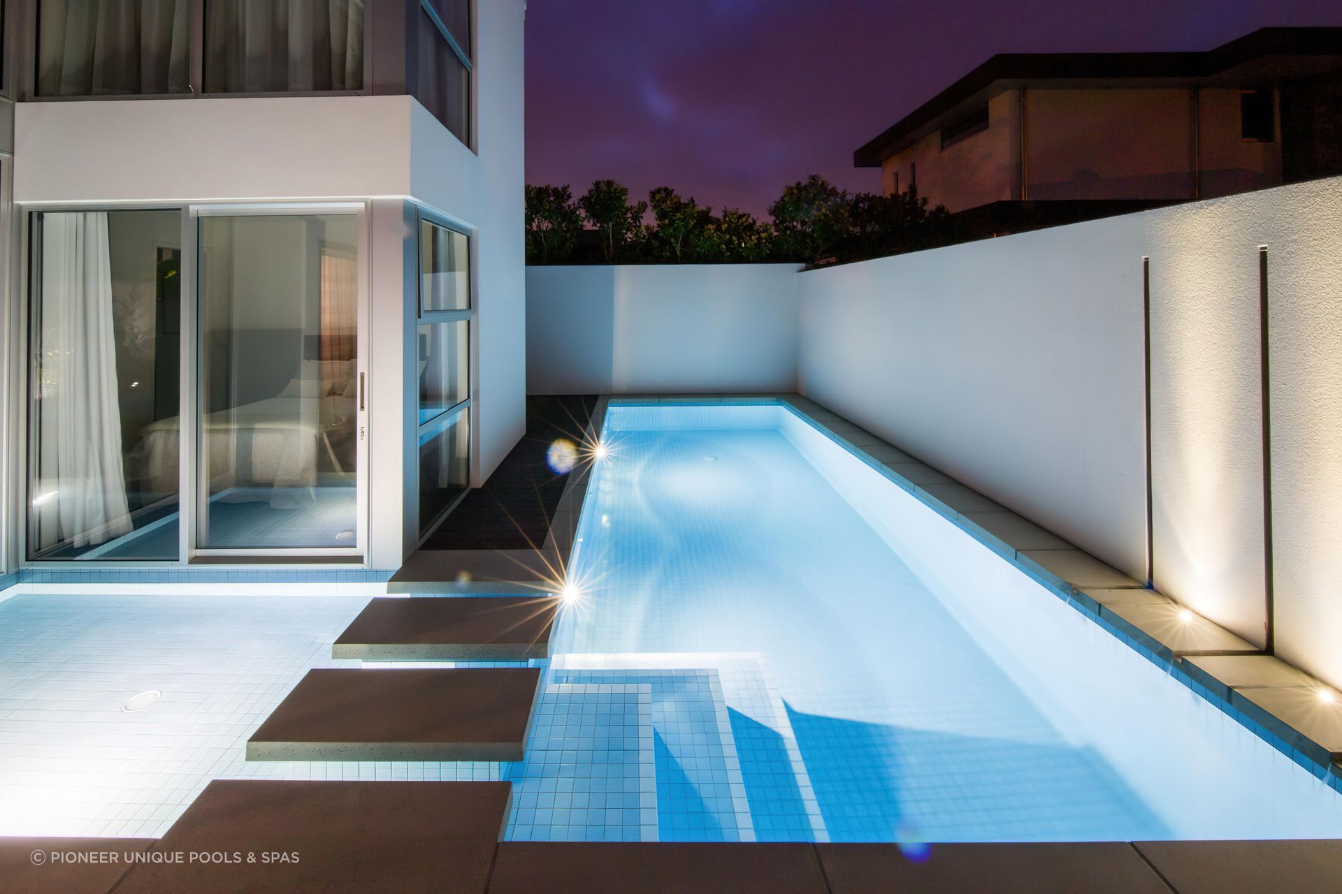 This shotcrete pool by Pioneer Unique Pools &amp; Spas makes use of every inch of its tight suburban site.