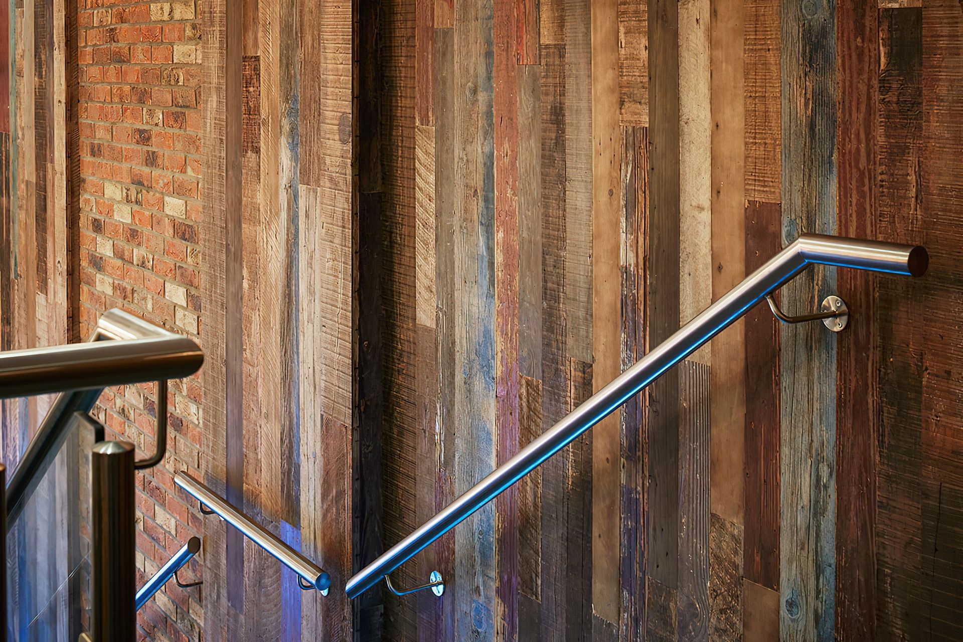 Reclaimed pine panels beautifully enhance staircases and other feature walls with their rustic charm. Featured product: REC2210 Organic Painted Pine