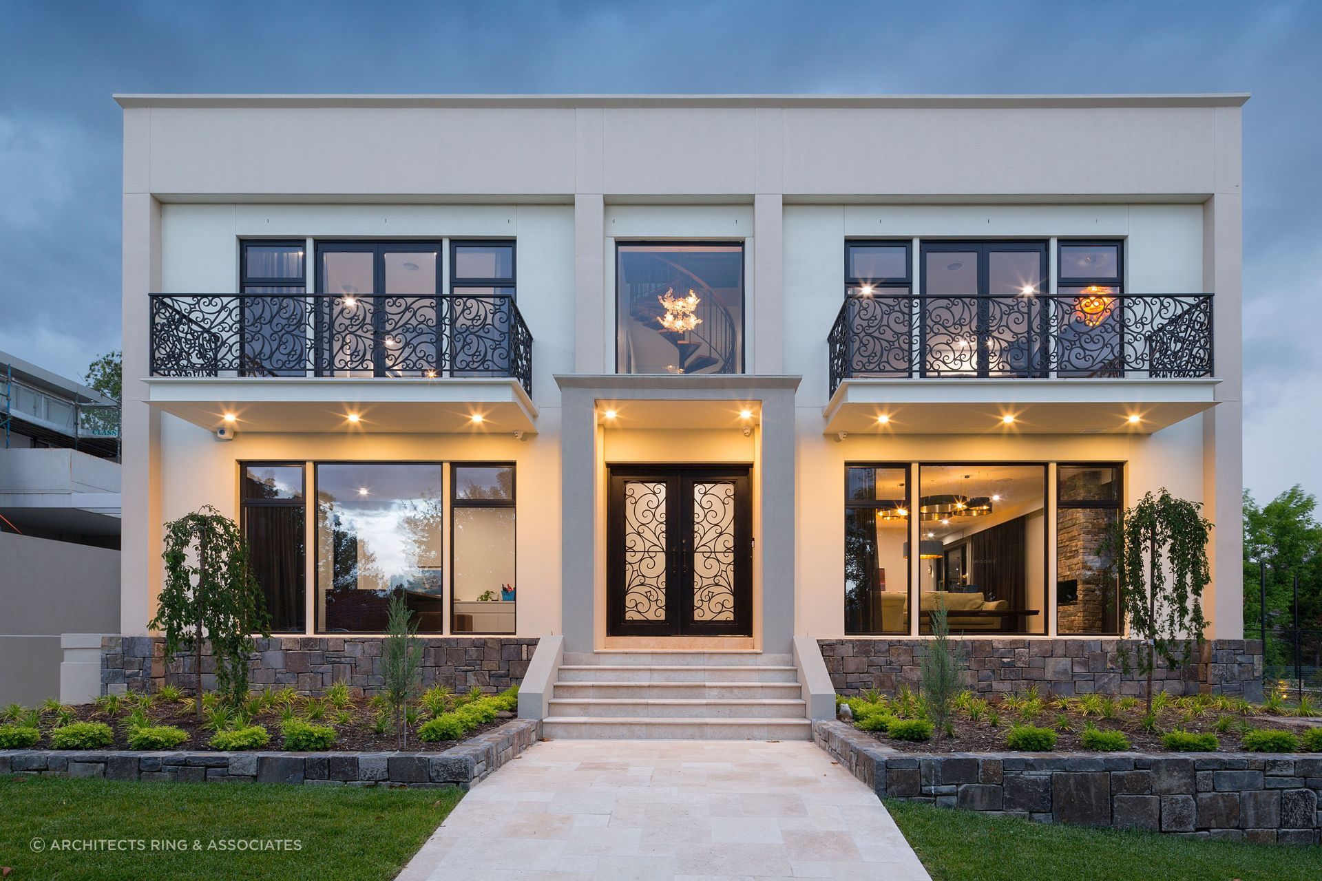 The entrance of this residence strikes a balance between tradition and modernity, with an elegant wrought-iron front door that offers both security and artistry. Featured project: Richardson by Architects Ring &amp; Associates