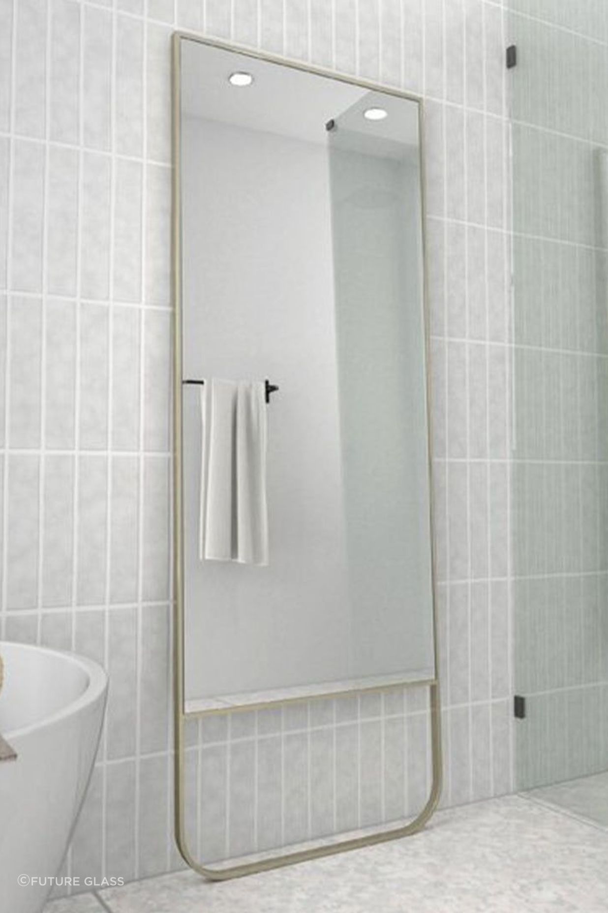 A full-length bathroom mirror adds depth and dimension to a bathroom. Featured product: Radius Leaner Framed Mirror.