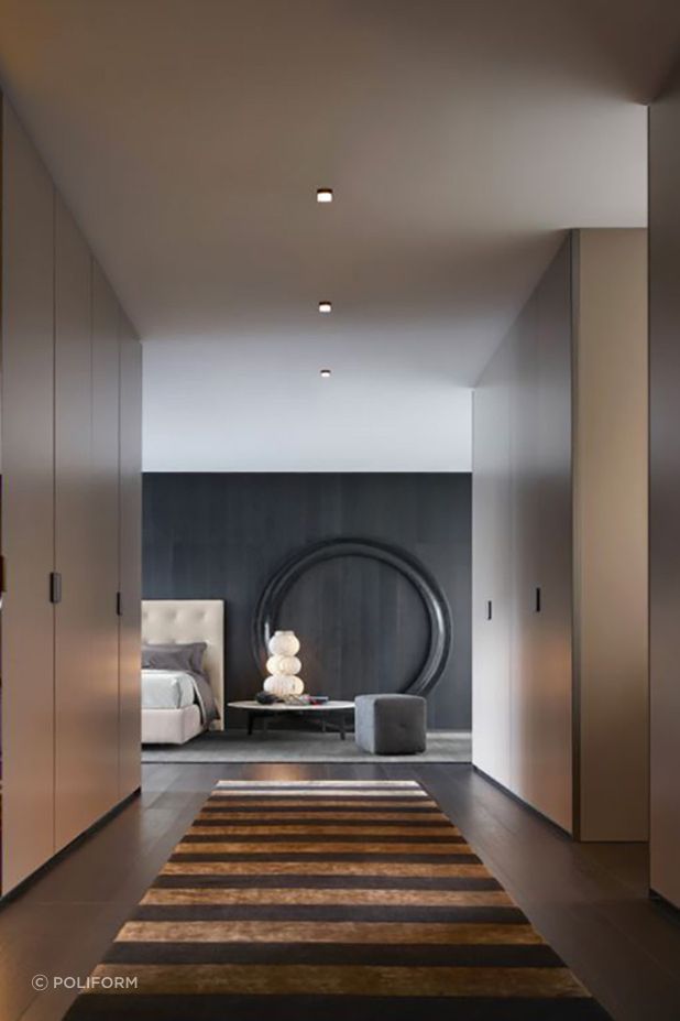 The Stripes Rug by Poliform beautifully complements the hardwood floor, creating a seamless transition into the bedroom