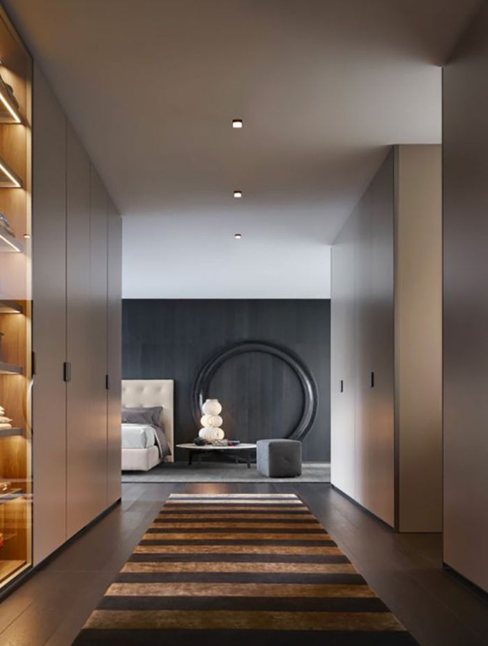 The Stripes Rug by Poliform beautifully complements the hardwood floor, creating a seamless transition into the bedroom