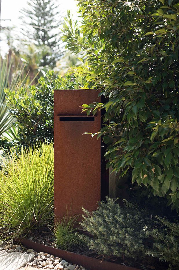 A rustic letter box takes pride of place in this garden