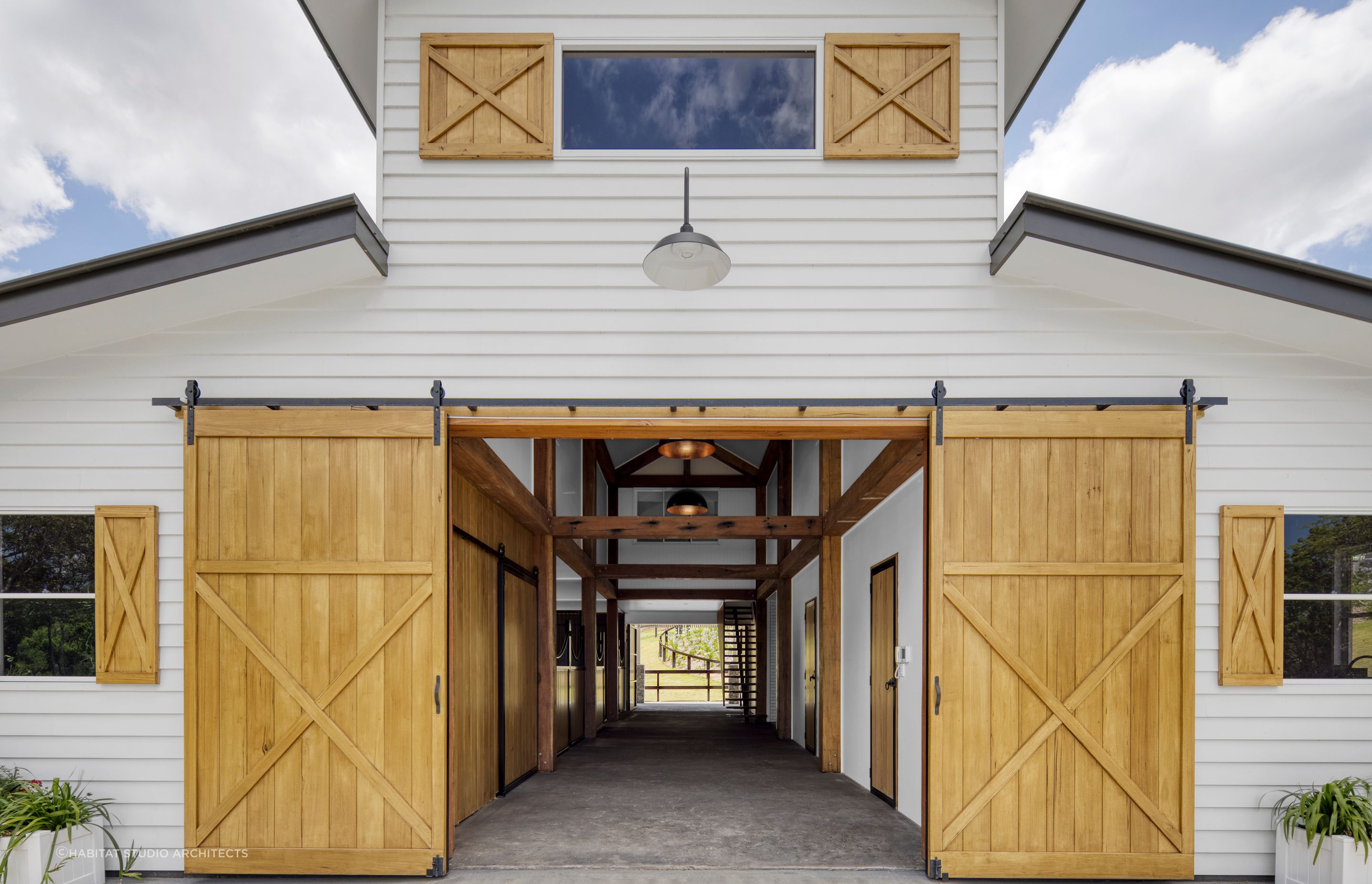Sliding barn style doors can be used at the front, back and sides of a barn house or farm style property. Featured project: Willow Vale Farm by Habitat Studio Architects