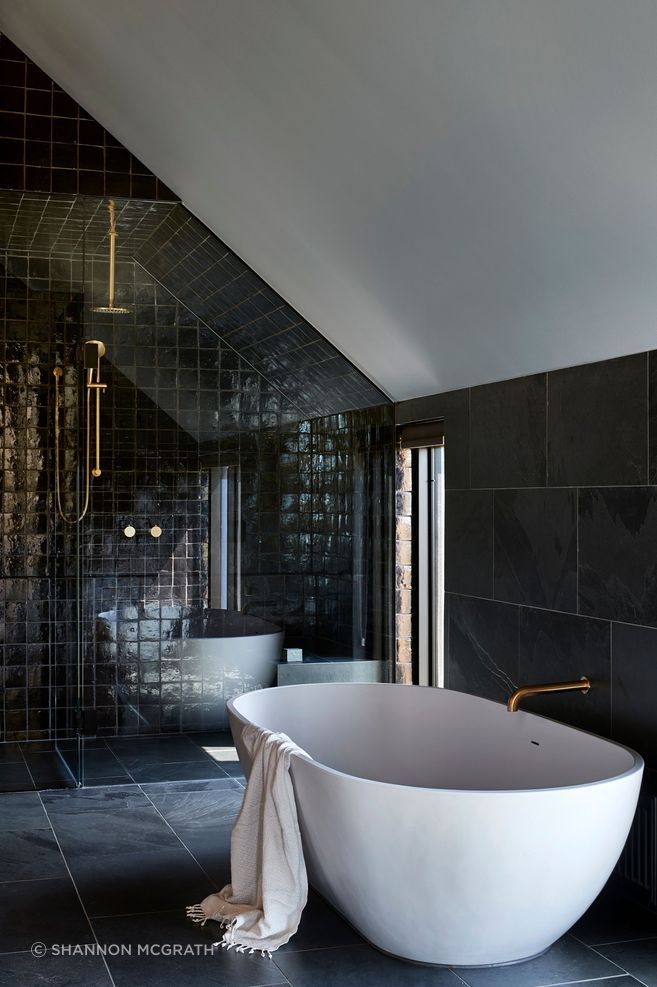 In the bathroom, dark stone and glazed tile create a more intimate expression of the home’s material palette, showing how specification can bring tactility, durability and mood to even the most private spaces.

Architecture: Abe McCarthy Architects