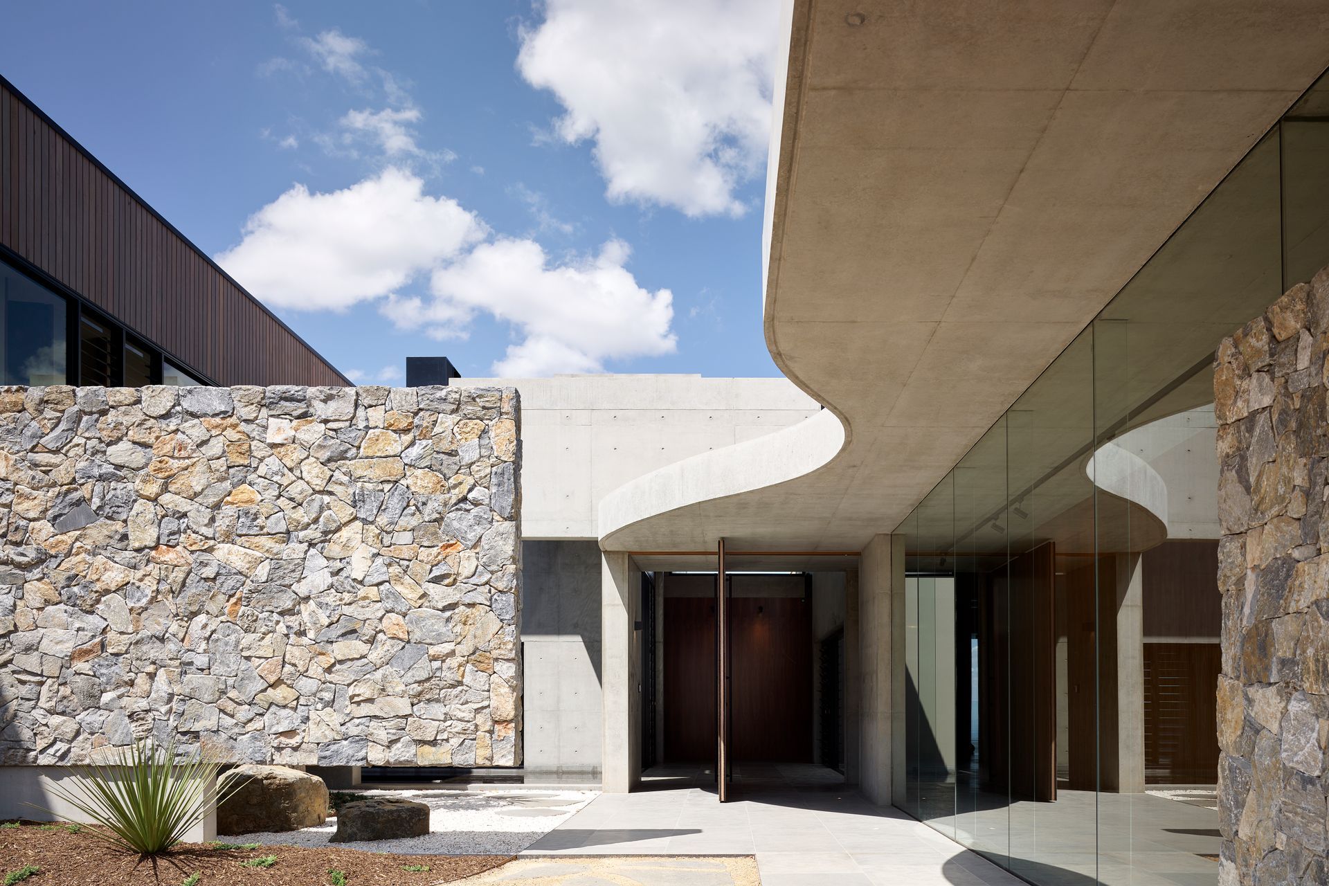Wamberal Freeform stone walling is ideal for residential and commercial applicatons. Here, it's been teamed with Andorra limestone pavers, which exhibit light grey hues. Photography by Scott Burrows.