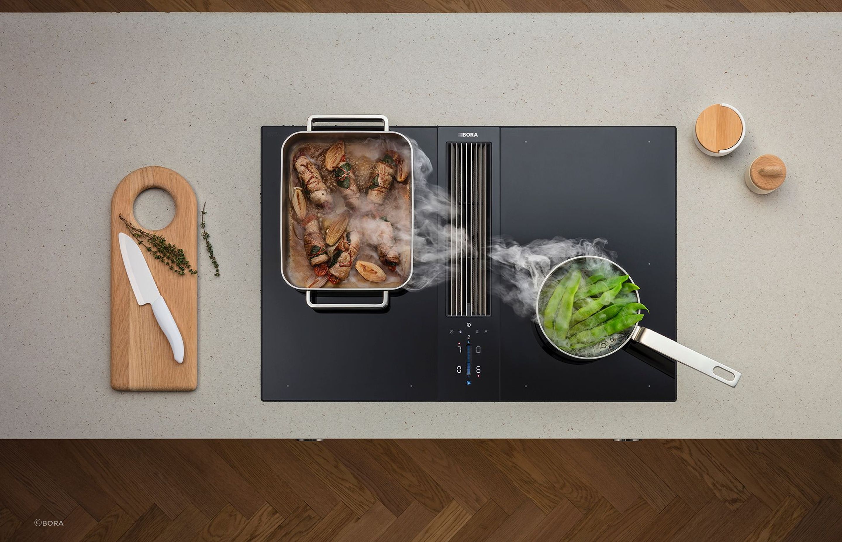 A large baking dish cools down on a Bora Classic 2.0 Combined Cooktop and Extractor