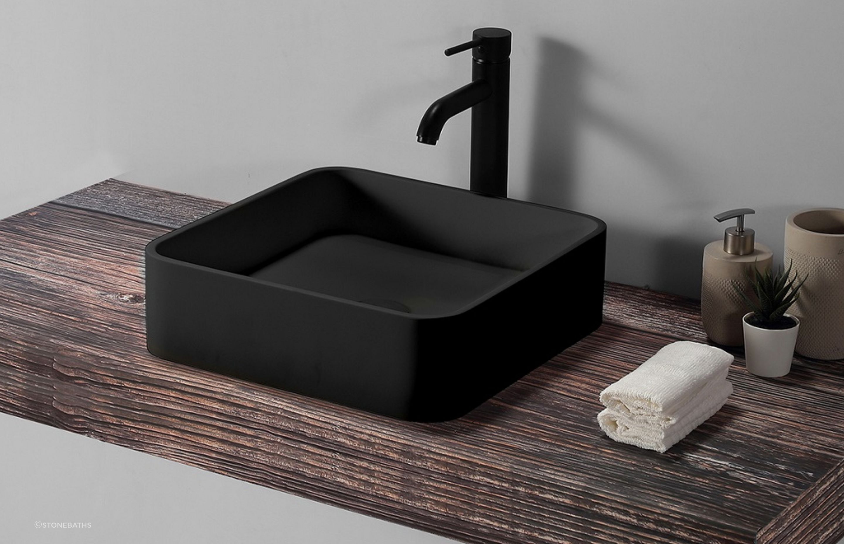 The beautiful B1700 Square Basin from Stonebaths the woooden panel adds a touch of natural beauty to the space