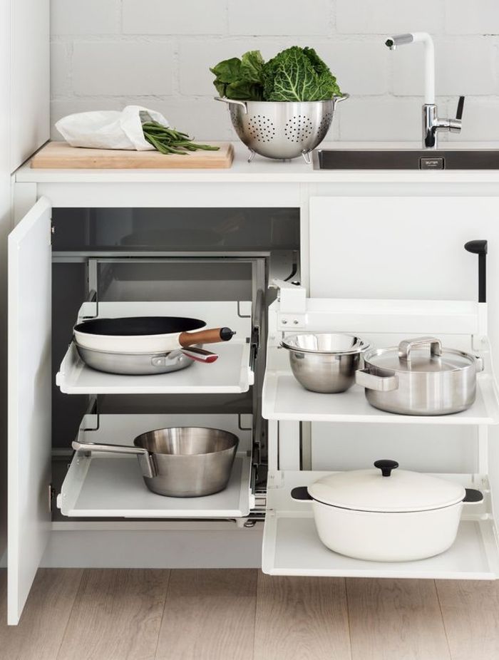 A colander in use, stored with other essentials in a Peka Magic Corner Storage Kit from Nover