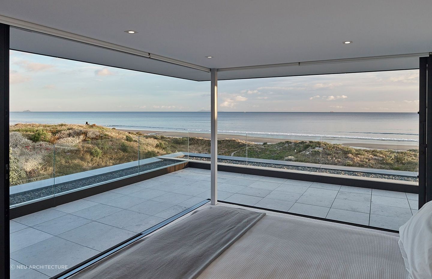Incorporating spectacular surroundings into the design of your bedroom, seen here in another amazing Mt Maunganui home, enhances its serenity appreciably. | Photography: Matt Quérée