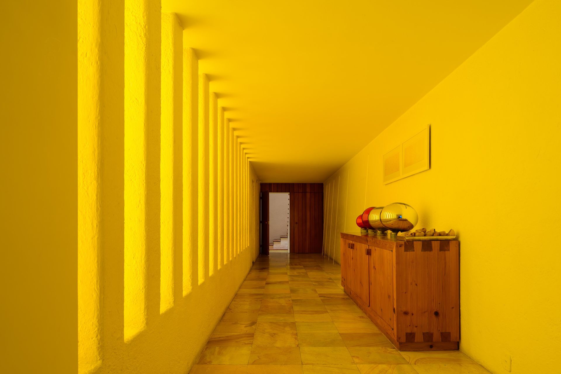 Coloured concrete can be complimented by a clever use of light. At Luis Barragán's Casa Gilardi, only one wall in the pool corridor is yellow, the other is white. Light enters through the adjacent courtyard, creating a warm glow.