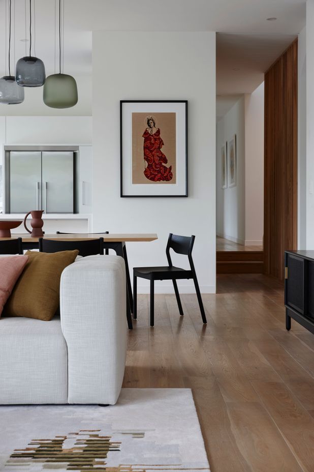 On an otherwise white wall, colour has been introduced with the addition of artwork in this space designed by Lulu Wilcox.