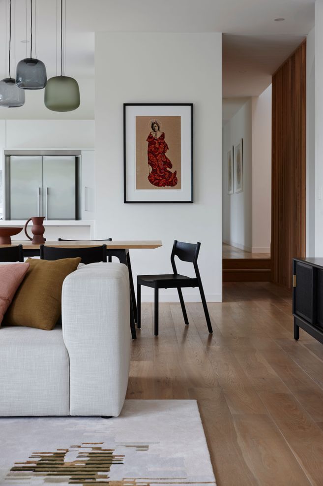 On an otherwise white wall, colour has been introduced with the addition of artwork in this space designed by Lulu Wilcox.