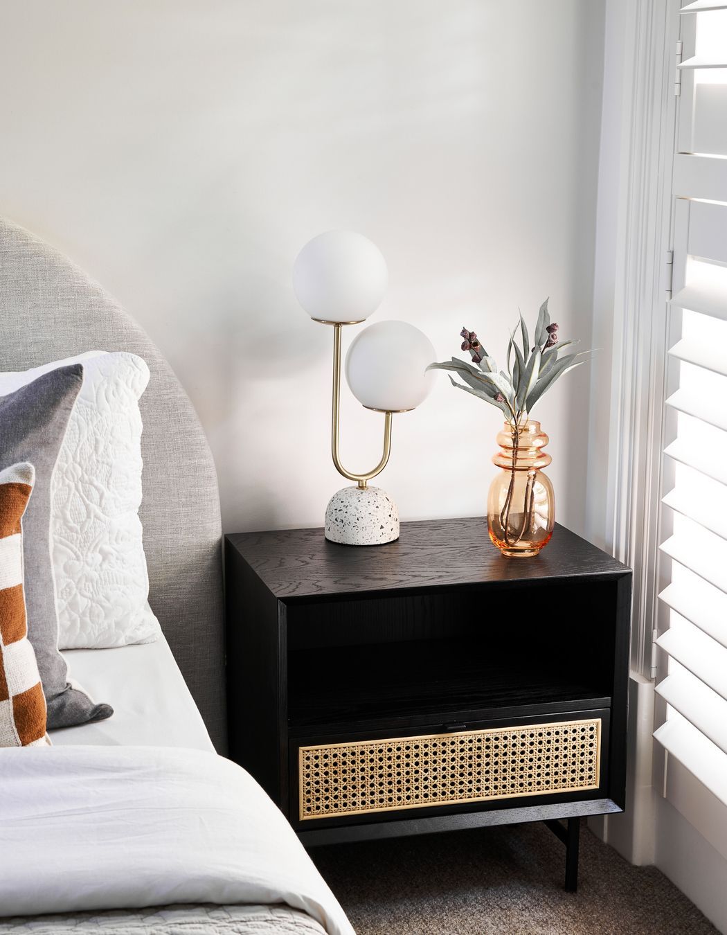 In addition to being used for stand-alone side tables, rattan is often incorporated as a design element in hardwood bedside tables, such as this Betty Side Table.