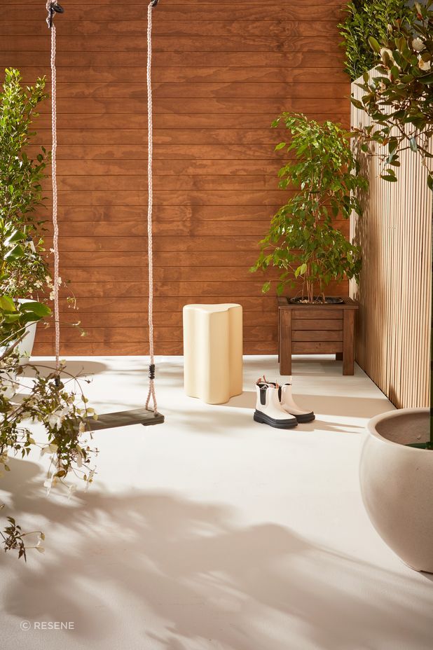Weatherboards finished in Resene Natural Wood Oil in Resene Egmont. Trellis finished in Resene Natural Wood Oil in Resene Aorangi. Floor in Resene Walk-on in Resene Merino.