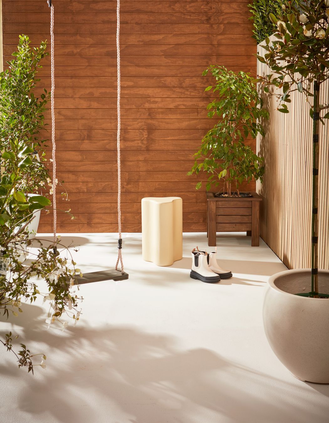 Weatherboards finished in Resene Natural Wood Oil in Resene Egmont. Trellis finished in Resene Natural Wood Oil in Resene Aorangi. Floor in Resene Walk-on in Resene Merino.