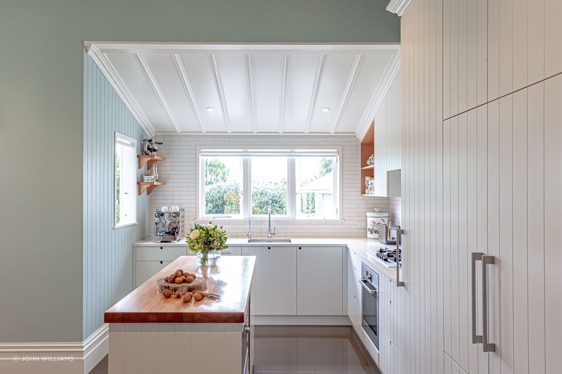 A subtle introduction of colour in this kitchen feels fresh, perfect for mornings spent gathered around the island bench | Grey Lynn Kitchen by Celia Visser Design