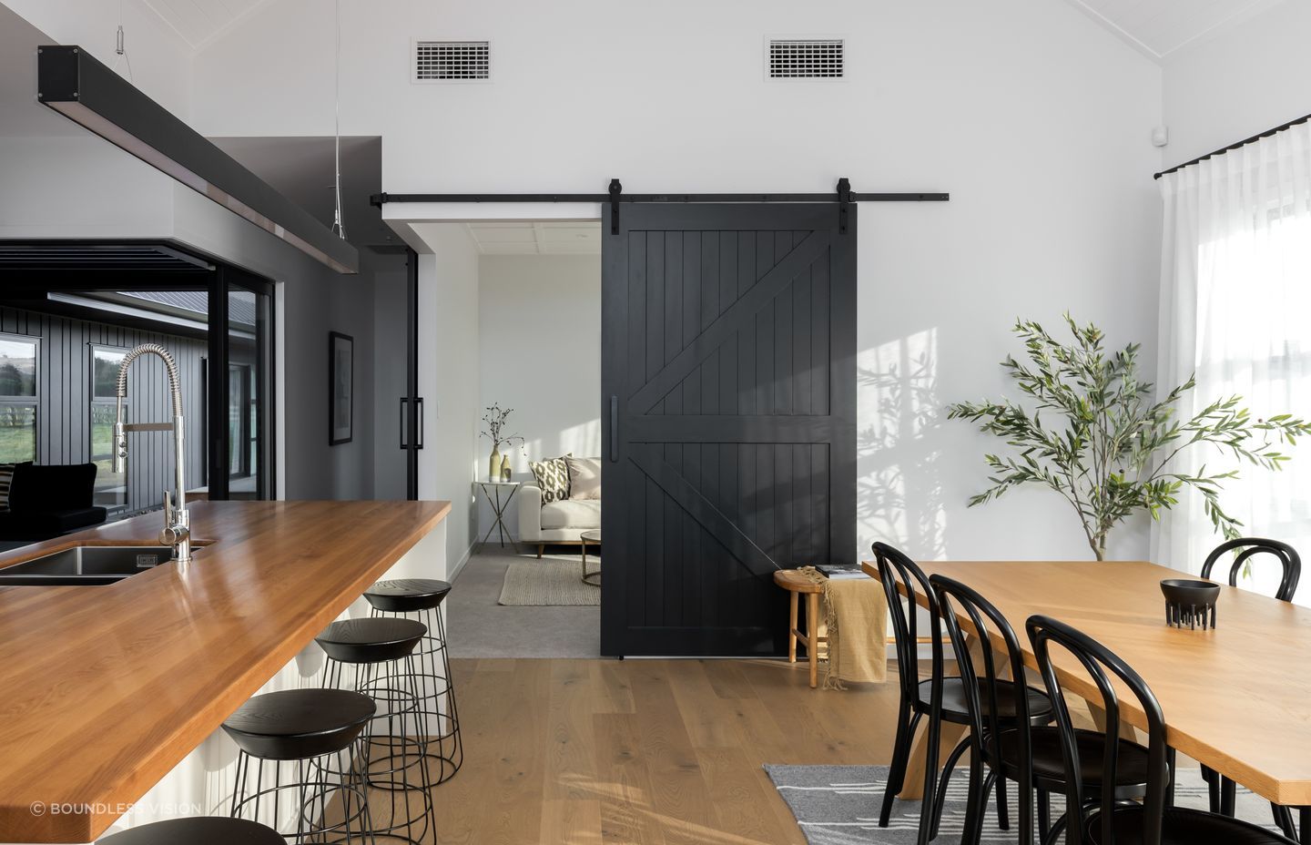 Cleverly placed barn-style doors separate or connect spaces on demand.
