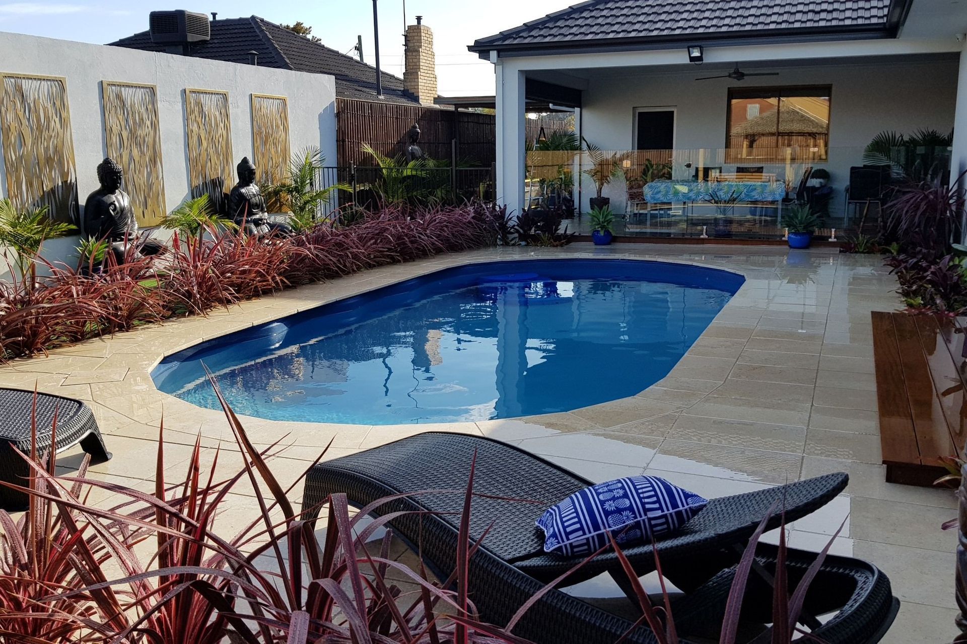 Oval pools, like the Classic Majestic Swimming Pool by Poolpac, enhance the natural feel of an outdoor living space.