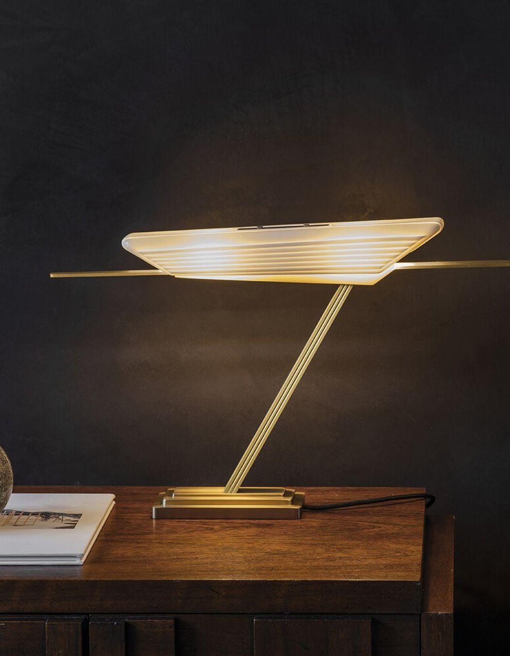 Exquisite materials that include a bone fine china shade and brass base with the Glaive Table Lamp
