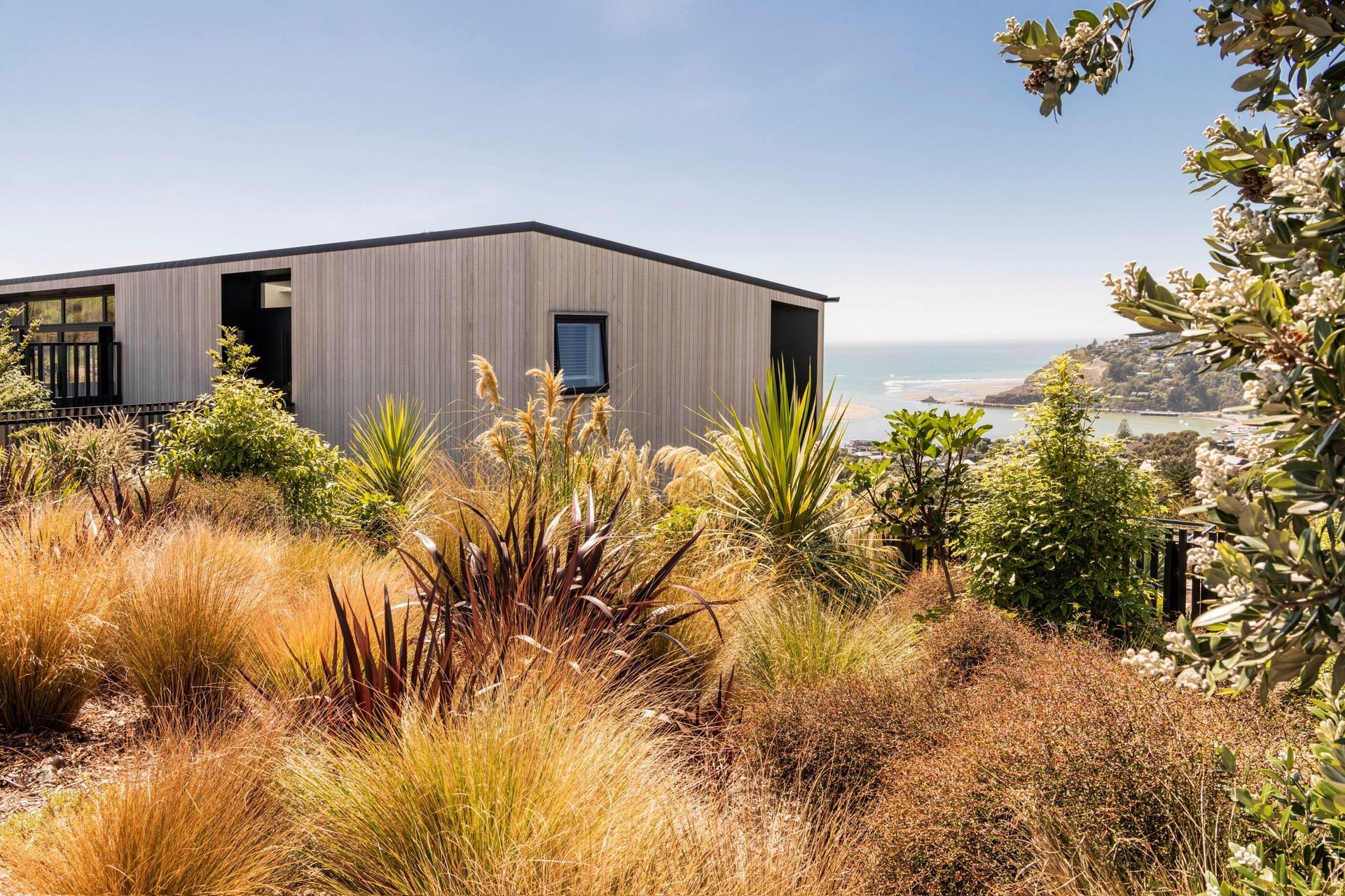 A wonderful example of naturalistic planting with some iconic natives in this hillside home in Christchurch. | Photography: Stephen Goodenough Photographer
