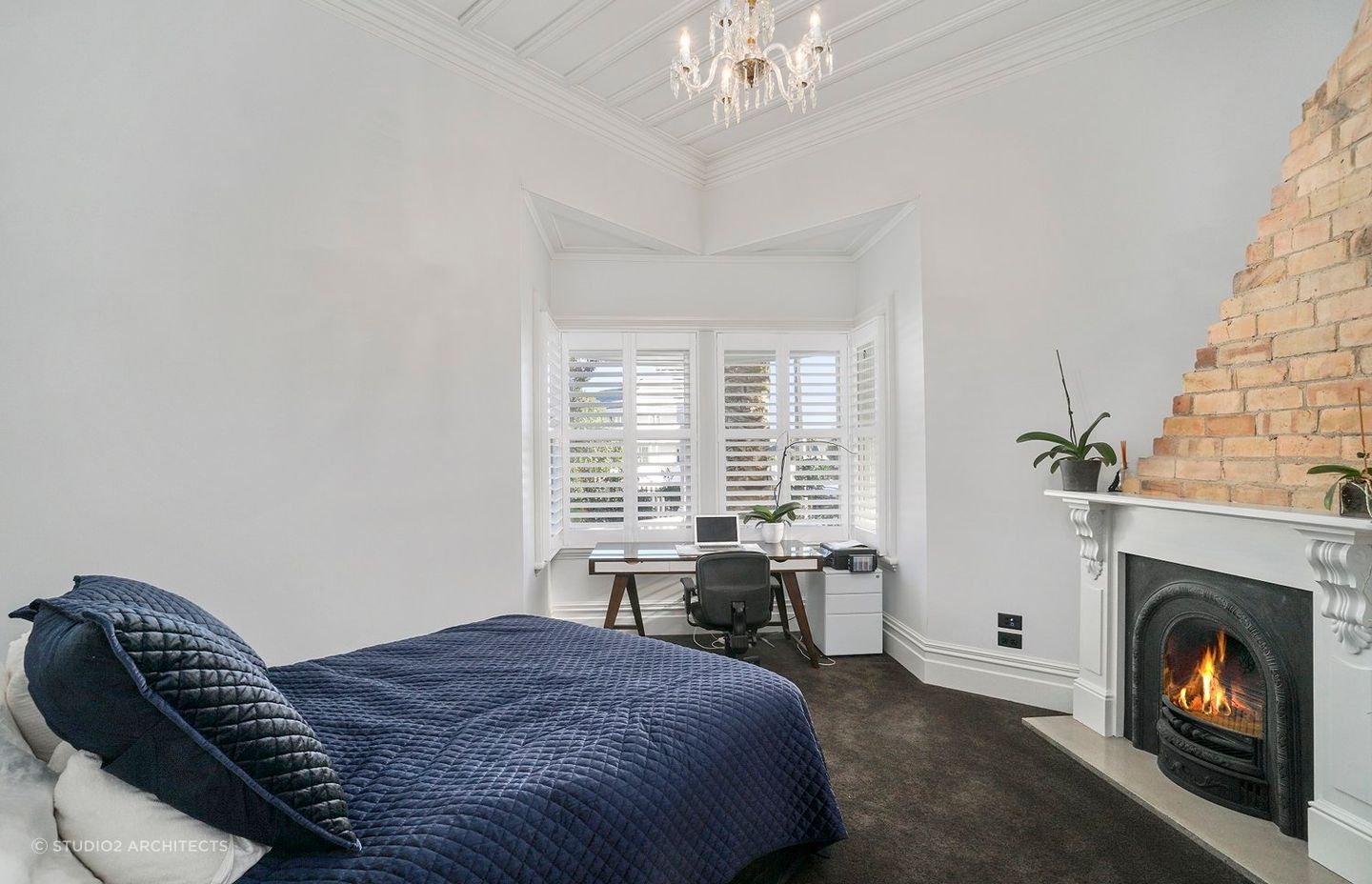 A roaring fireplace in a bedroom makes it an easy place to retreat to, seen here in this marvellous villa renovation in Herne Bay.