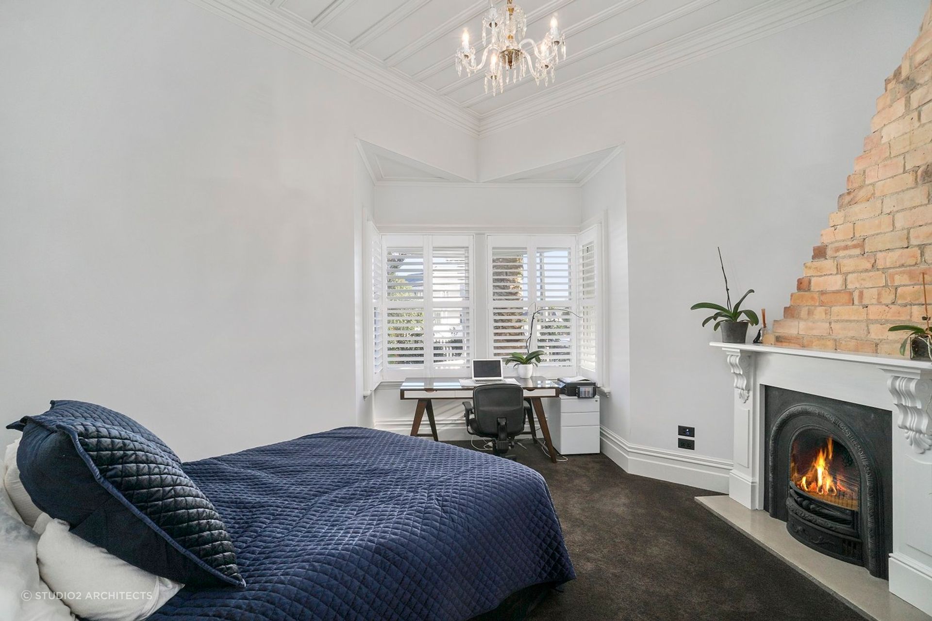 A roaring fireplace in a bedroom makes it an easy place to retreat to, seen here in this marvellous villa renovation in Herne Bay.