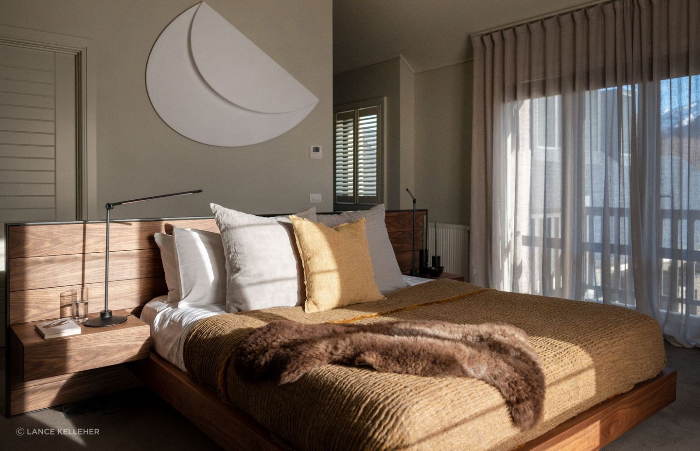 Combining textures, like the natural hardwood bed frame and soft bedding of this gorgeous South Island home, adds warmth and visual interest to a bedroom.
