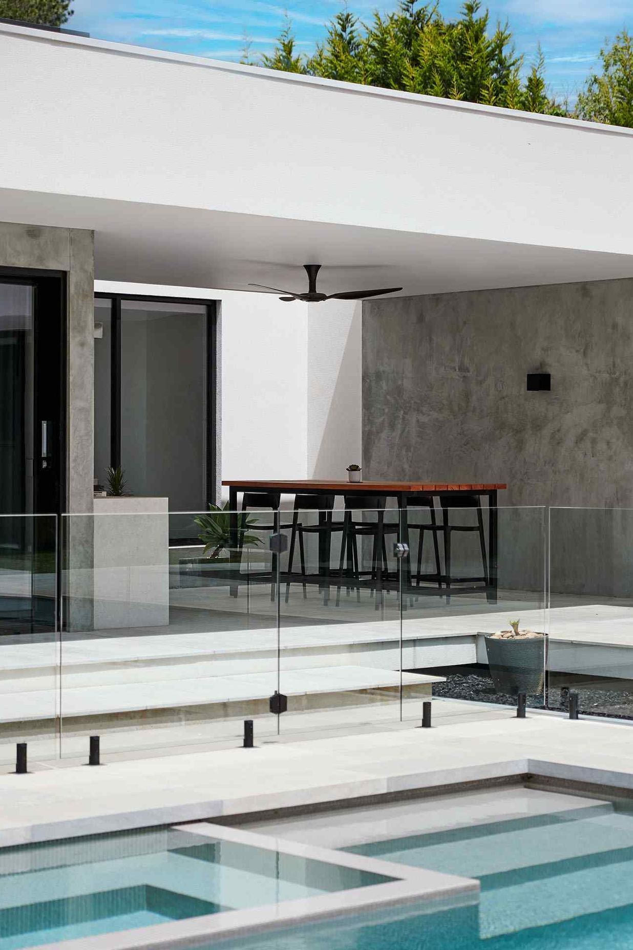 The framless glass allows the spaces to seamlessly connect.