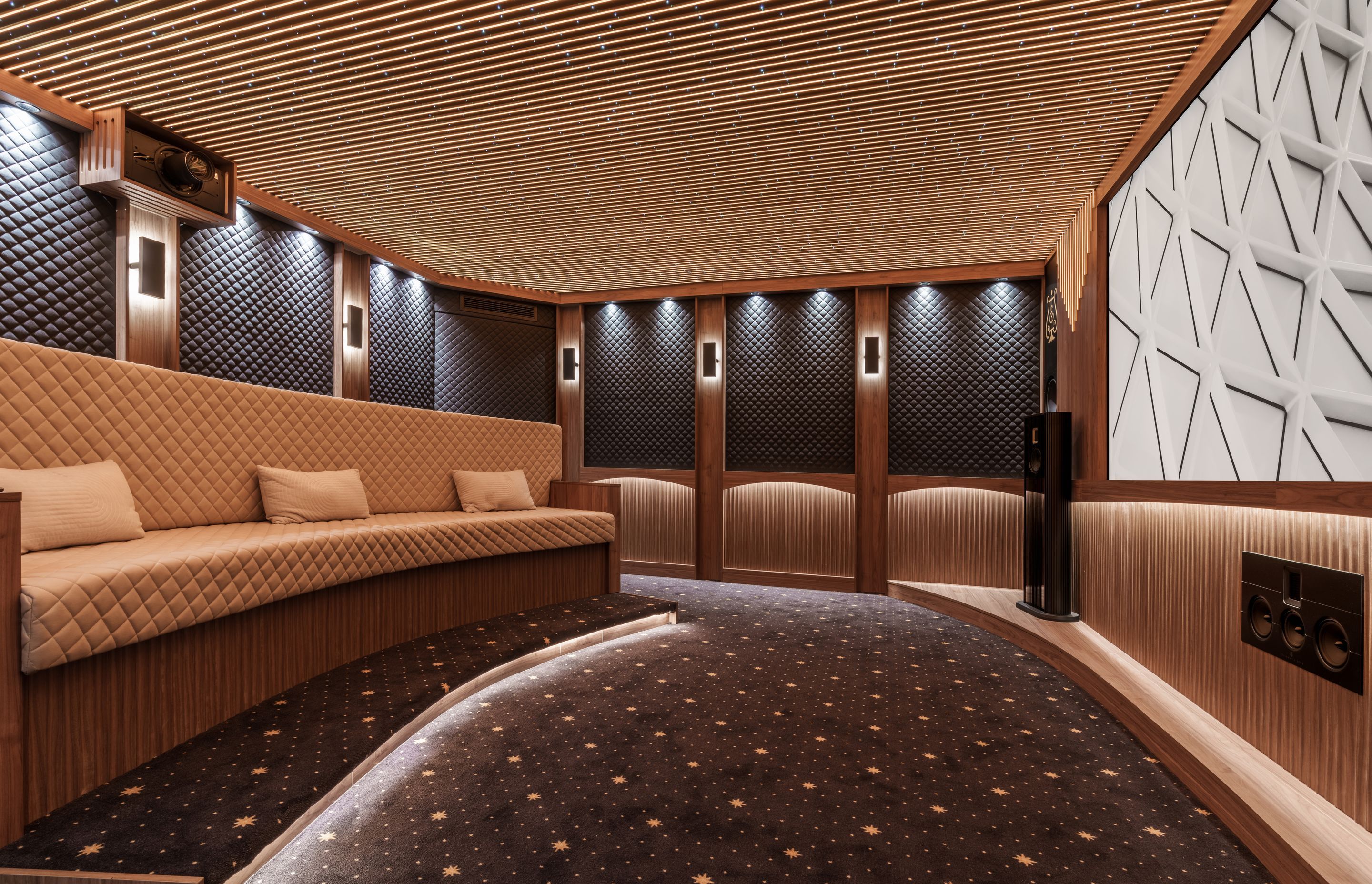 In this home theatre set-up, the projector is mounted high on the wall and projects onto the opposite wall.