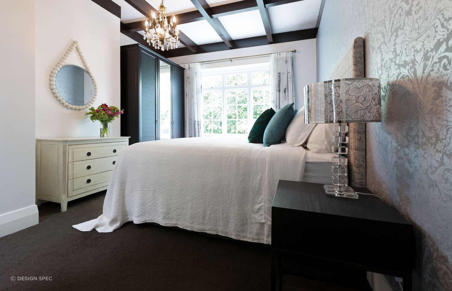 Warm toned bulbs, like those in the exquisite chandelier in this Pukenui Road residence, combine well with natural light to bring comfort to a space.