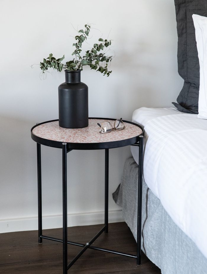 This Round Side Table works as a functional nightstand.