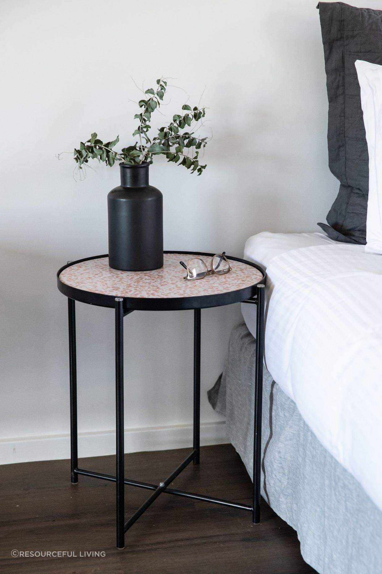 This Round Side Table works as a functional nightstand.