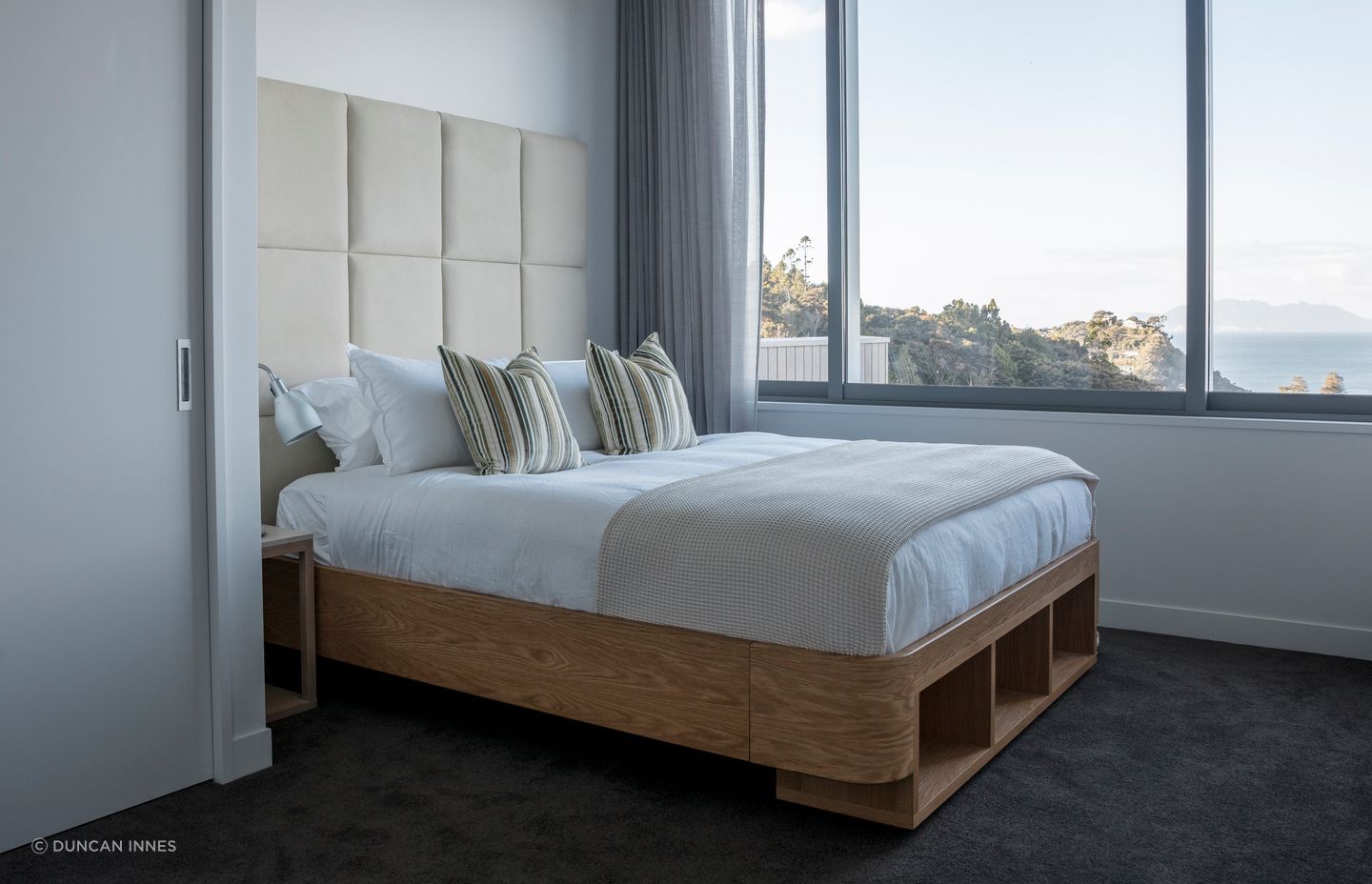 This Sarsfield Brooke custom bed was locally made for the Matakana home. Offering a design and make service to include headboards, beds, wooden furniture pieces and rugs.