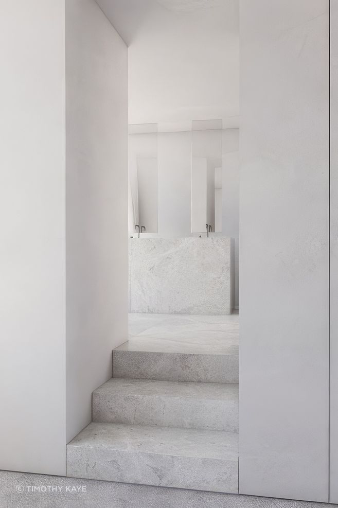 Precise junctions create a sense of calm in the bathroom of St Kilda House.