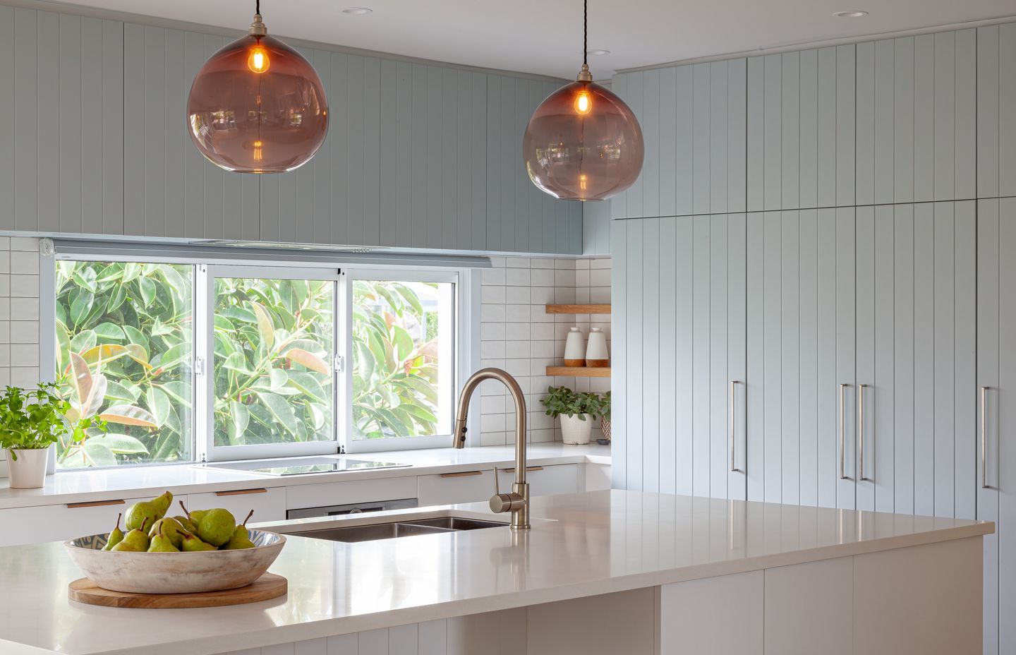 The tongue and groove Kawhia profile (shown here in Villa Blue) works everywhere from coastal home to classic villa. Design by Michelle McAnulty, Beaver Kitchens.