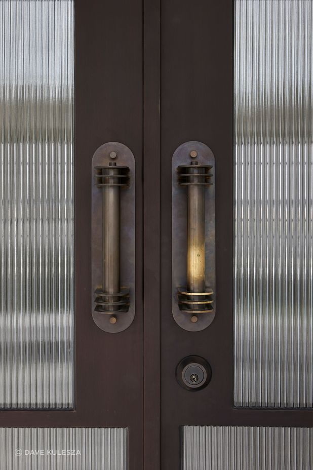 Custom brass pull handles were fabricated for the entry doors.