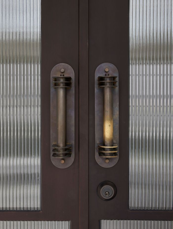 Custom brass pull handles were fabricated for the entry doors.