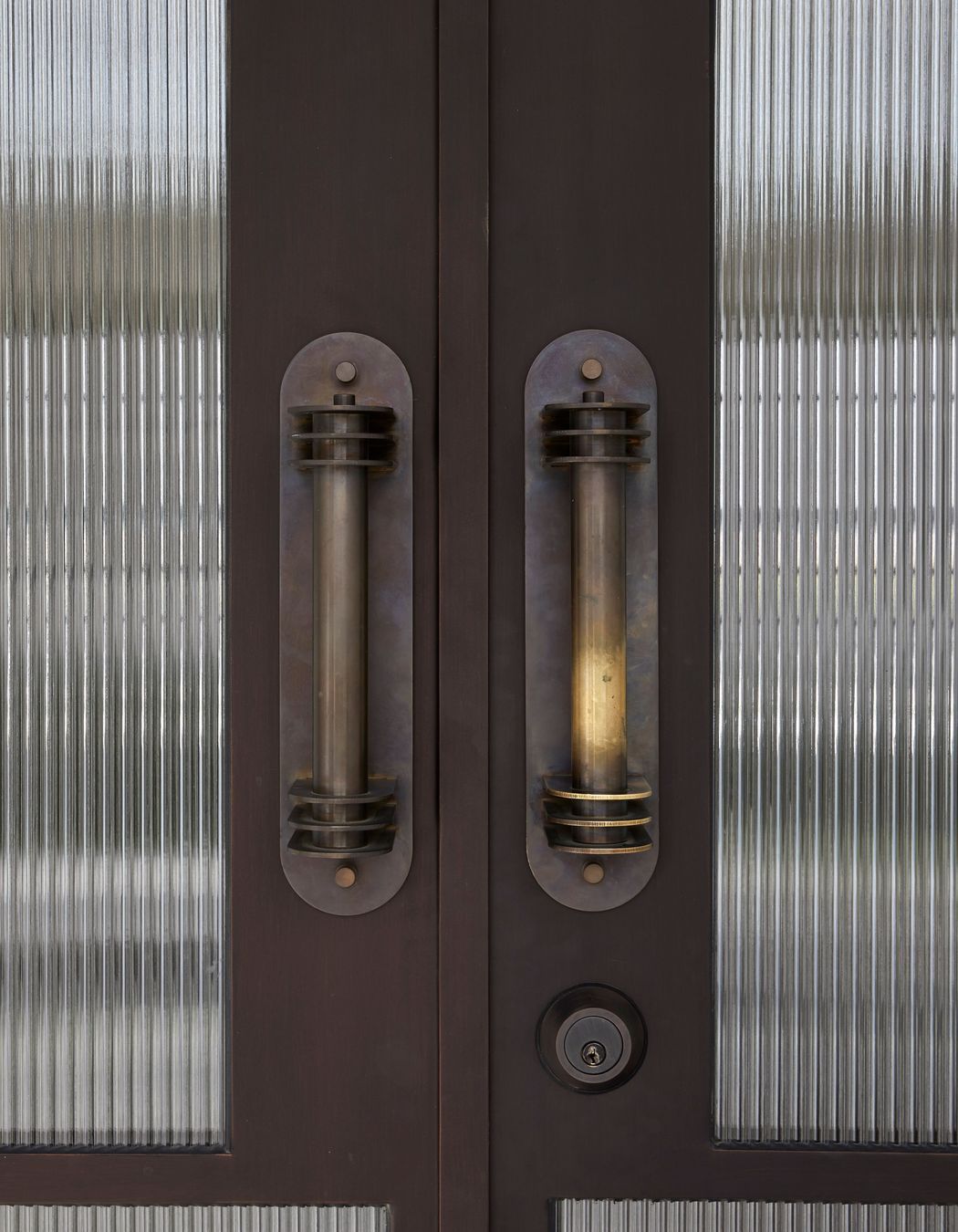 Custom brass pull handles were fabricated for the entry doors.