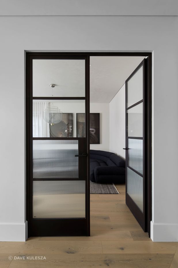The black steel frame doors bring a modern touch to the Art Deco-inspired home.
