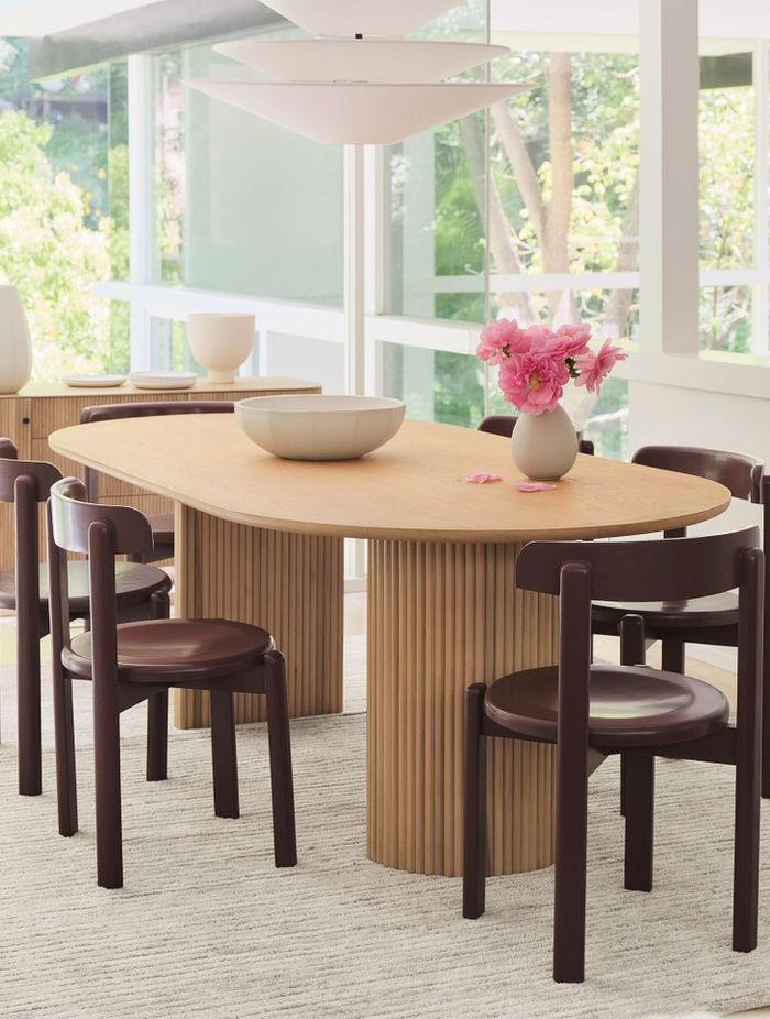 The solid wood Bryant Dining Chair's minimal silhouette leans into a vintage aesthetic.