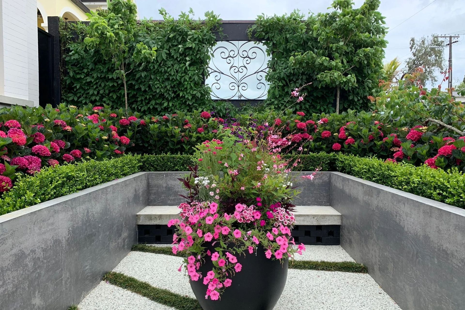 Pink blooms delight in this intimate garden.