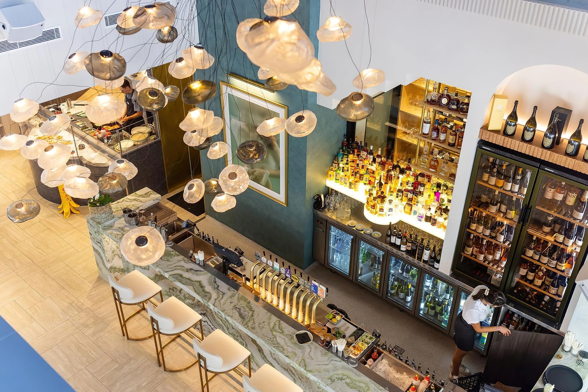 The largest Bocci commission in Australia to date, the cluster of 61 hand-blown Bocci 73 Series glass lights transform the Blowfish Ocean Grill + Bar on the Gold Coast designed by Space Cubed Design Studio. Photography by Harley McNamee courtesy of Bocci