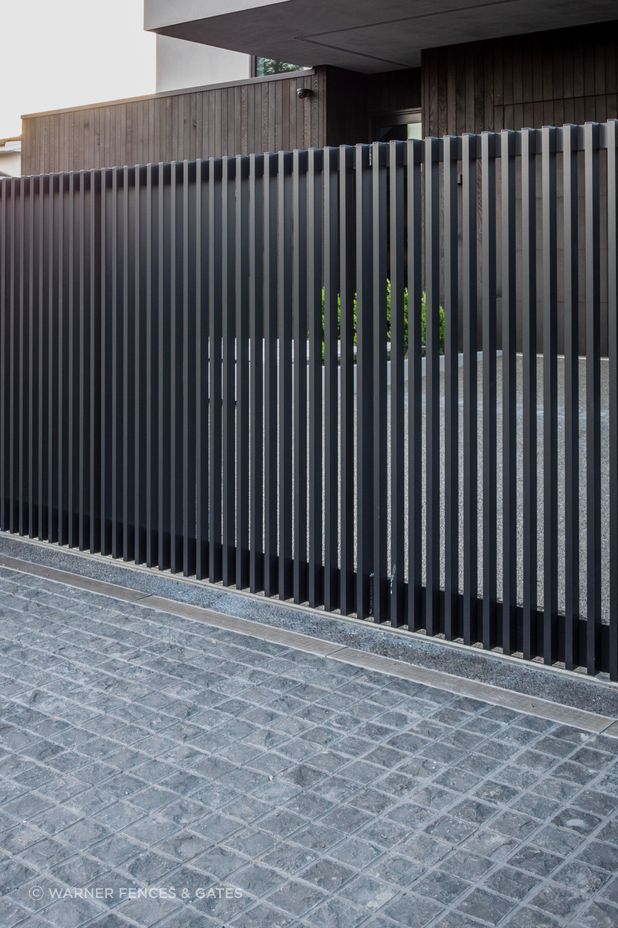 The sliding drive gate is automated and equipped with safety beams.