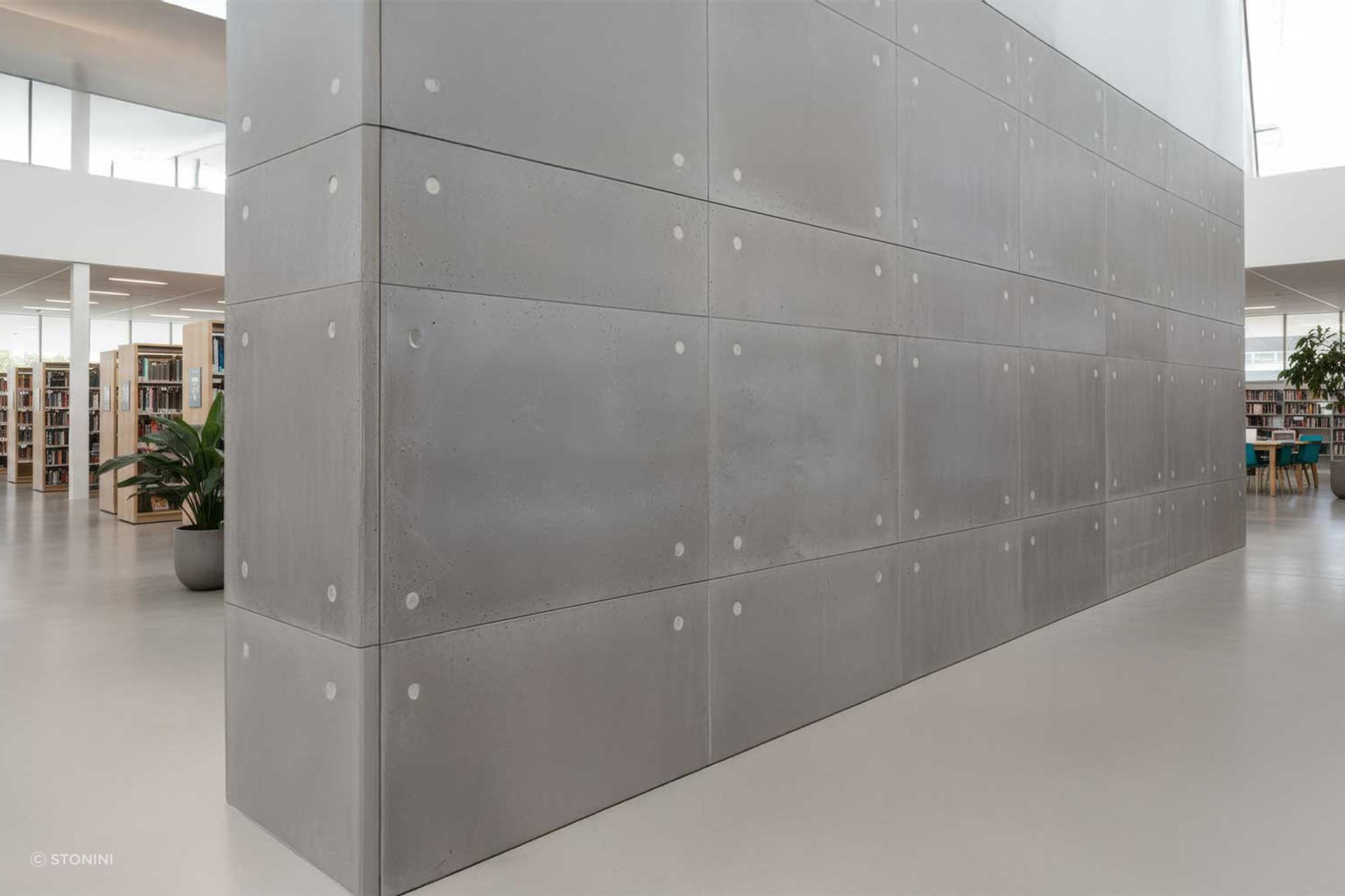 Artist’s impression: A modern library featuring lightweight concrete wall panels with anchor bolt holes, offering a low VOC, fire-rated solution for public spaces